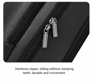 Detailed macro view of dual metal rectangular zippers on black pebble leather backpack