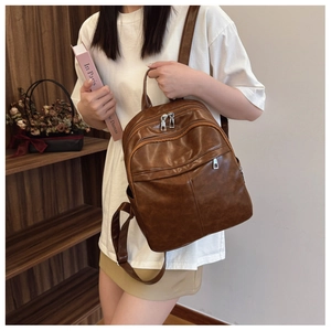Lifestyle view of a vintage brown multi-pocket leather backpack for travel and school
