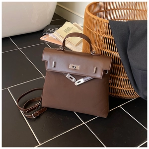 Close-up of vintage brown leather bag with classic Kelly buckle and silver hardware details
