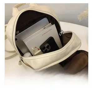 Detailed interior of the soft faux leather backpack showing multiple storage compartments