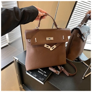 Detail view of the vintage brown matte leather backpack with silver turn-lock and handle