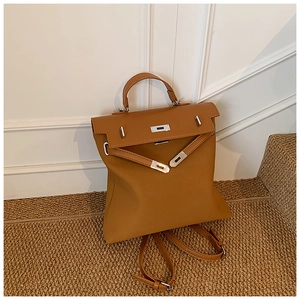 Detail of camel leather backpack with lychee grain texture and classic metal twist lock