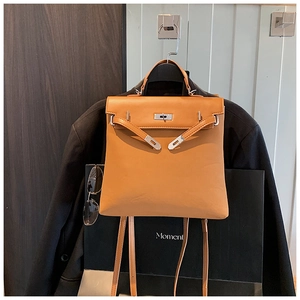 Detail of light brown leather backpack showing silver hardware and stylish toggle closure