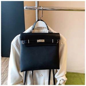 Detailed view of black matte leather convertible backpack with silver Kelly-style buckle lock