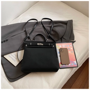 Flat lay of black vintage multi-functional backpack with stylish accessories and tablet
