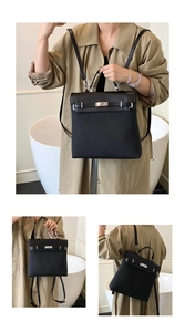 Detail of black matte trapezoidal backpack featuring a silver twist lock and slim straps