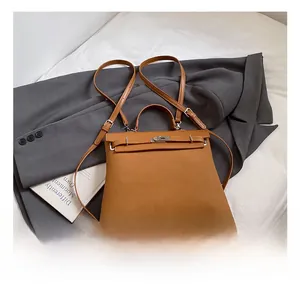 Detail of tan suede texture and classic buckle closure on a retro dual-use backpack