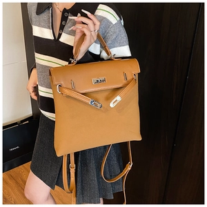 Detail of camel brown vintage backpack with silver turn-lock and adjustable straps