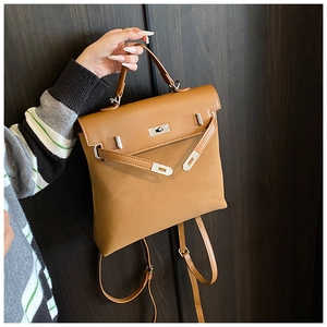 Detailed view of caramel leather backpack with silver lock and matte vintage texture