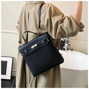 Detailed view of a black frosted textured Kelly bag with silver metallic twist lock