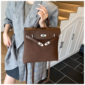 Detailed view of dark brown frosted leather texture and silver buckle on the vintage handbag