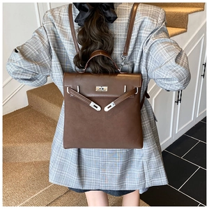 Brown frosted leather backpack with silver metallic clasp shown on female model