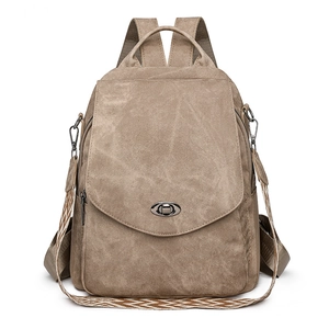 Brown canvas travel backpack with bohemian strap and metallic twist lock closure