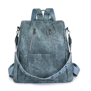 Blue retro PU leather backpack with dual zip pockets and colorful woven shoulder strap