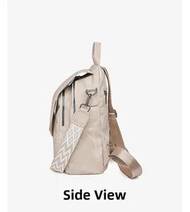 Side view of beige fabric backpack with patterned wide strap and double zippers