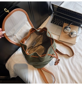 Close-up of drawstring closure and interior lining of green canvas backpack
