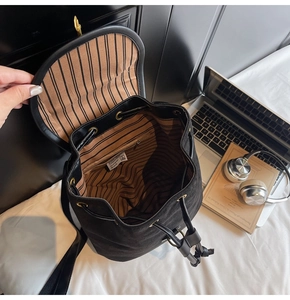 Detail view of large capacity backpack interior showing striped lining and zipper pocket