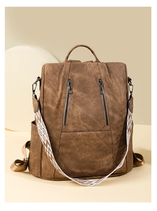 Detail of vintage brown backpack with retro texture and geometric pattern shoulder strap