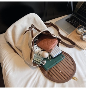 Top view of open bucket bag showing large capacity for wallet, umbrella and perfume