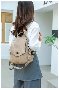 Close-up of khaki casual backpack with geometric pattern woven shoulder strap detail