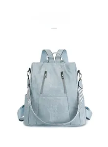 Front view of grey-blue ladies' anti-theft backpack with patterned jacquard strap