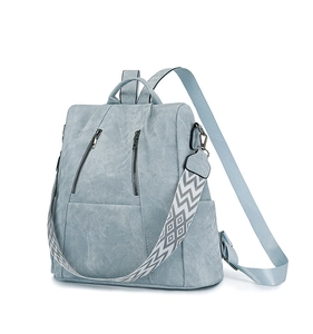 Detail view of ice blue backpack with dual front zippers and patterned boho strap