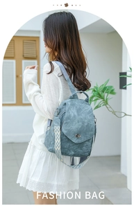 Detail of blue soft leather backpack with ethnic geometric woven wide shoulder strap