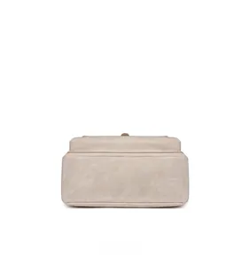 Detailed view of the reinforced bottom stitching on this beige canvas backpack
