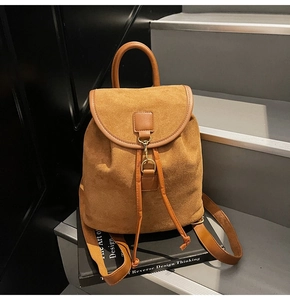 Detail of vintage brown frosted leather backpack with drawstring and metal hook closure
