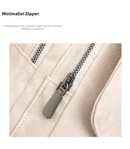 Detail of minimalist gunmetal zipper on beige canvas backpack with smooth closing