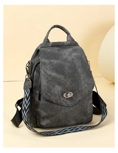 Detailed view of dark grey textured backpack with jacquard strap and silver metal lock
