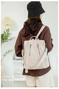 Detail of beige faux leather backpack with geometric pattern embroidery wide strap