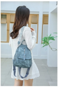 Close-up of blue PU backpack with vintage texture and geometric pattern shoulder straps