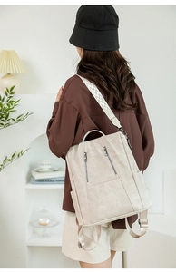 Detailed back view of beige backpack with stylish geometric wave woven shoulder straps