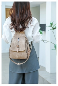 Brown PU leather backpack with decorative woven geometric strap and back zipper detail