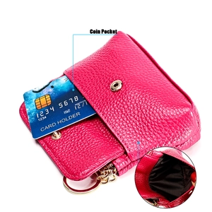 Macro detail of rose red lychee leather wallet with gold hardware and card slot
