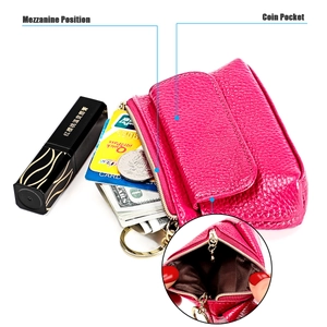 Macro view of rose leather coin purse showing mezzanine slots and metal keychain ring