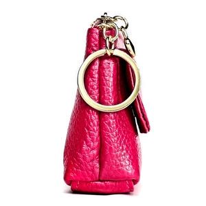 Detailed side profile of rose red pebbled leather coin purse with gold ring hardware