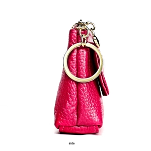Side view of rose pink leather coin purse showing textured grain and gold metal hardware