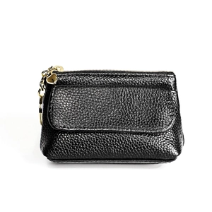 Close-up of black litchi leather coin purse with golden keychain and heart pendant