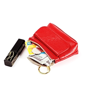 Macro shot of red leather coin purse with golden zipper showing interior storage space