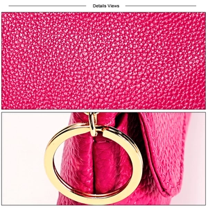 Close-up of rose pink pebble grain leather coin purse with polished gold hardware details