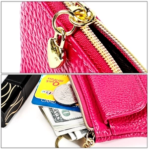 Detail of rose red leather coin purse featuring a golden heart zipper and card slots
