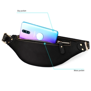 Detail view of leather waist bag showing main pocket and zip pocket with a phone