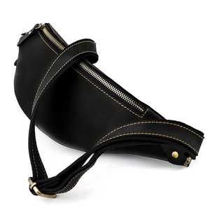 Detail view of vintage black leather waist bag with contrast yellow stitching and metal zipper