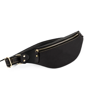 Close-up of black crazy horse leather fanny pack with vintage metal hardware and rivets