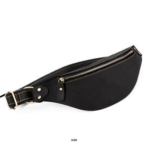 Side view of retro black leather waist bag with yellow stitching and brass zippers