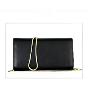 Detail of minimalist black matte leather envelope bag with sleek gold snake chain strap