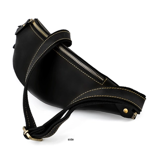 Close-up of black leather waist bag featuring contrast yellow stitching and metal zipper