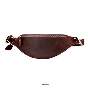 Front view of a vintage dark brown crazy horse leather waist bag with bronze metal zippers